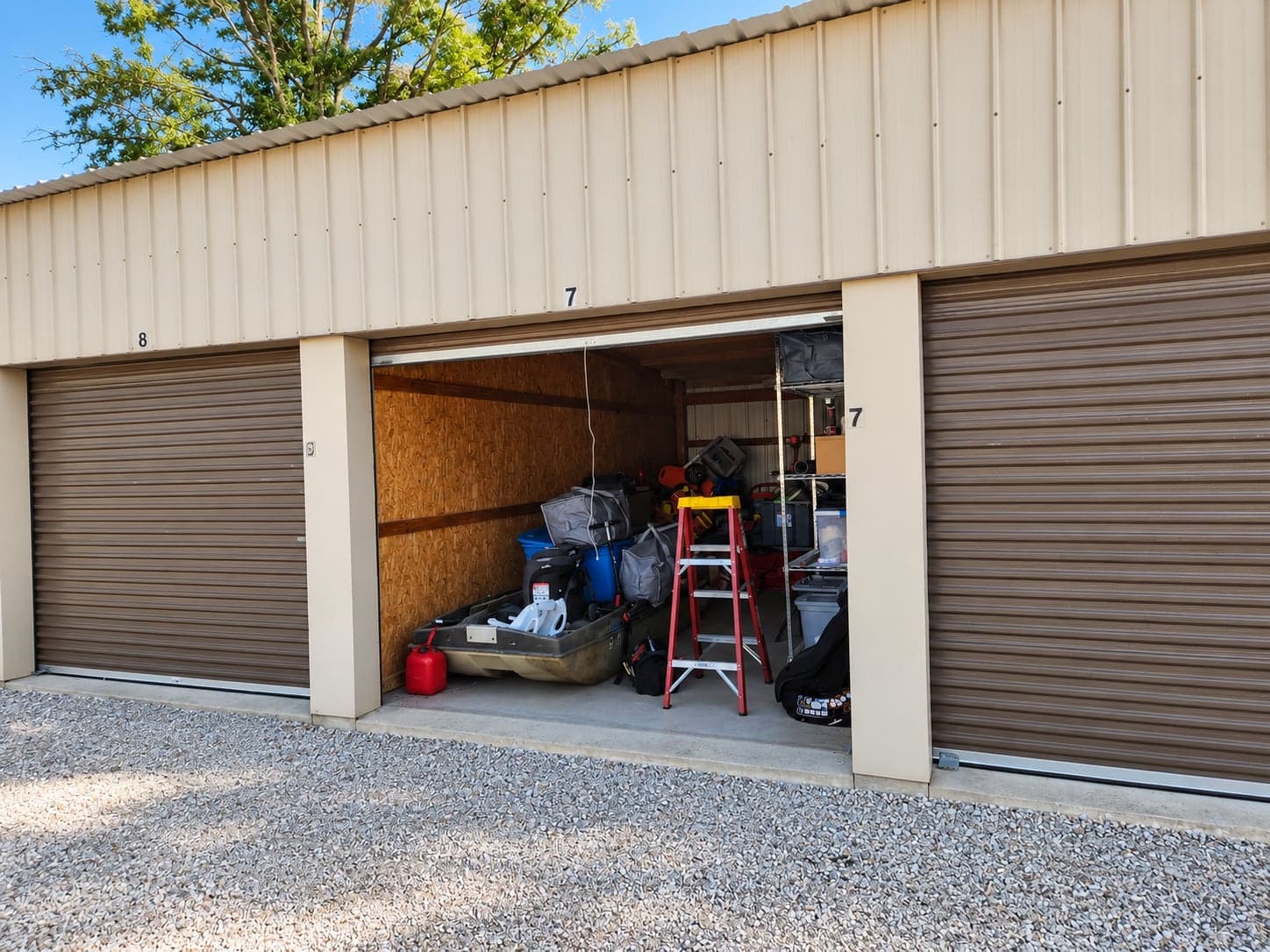 A storage building with a row of brown doors, one open